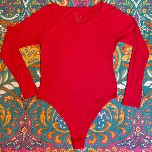 A new day long sleeve red button body suit